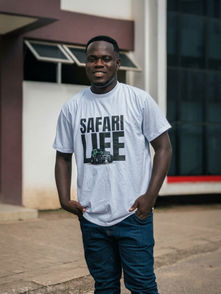 A young african guy in the white colorway of the Safari Life Tee from DripAfrika